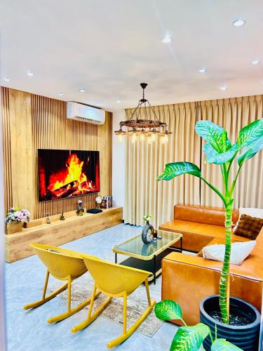 a living room with a table and a fireplace at Studio 19 Diamond-2bedroom apartment in Gaborone