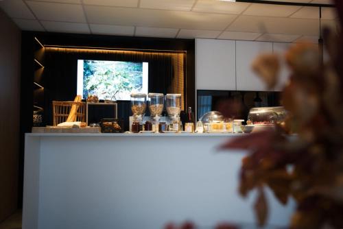 a counter in a kitchen with glasses on it at Logis Restaurant & Hôtel À la 12 in Delme