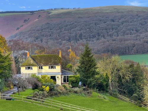 a house on a hill with a green yard at Backwoods Annexe Middlecome in Minehead