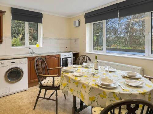 a kitchen with a table with a table cloth on it at Backwoods Annexe Middlecome in Minehead