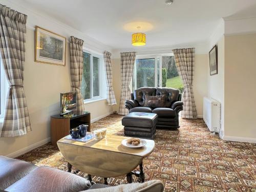 a living room with a couch and a table at Backwoods Annexe Middlecome in Minehead