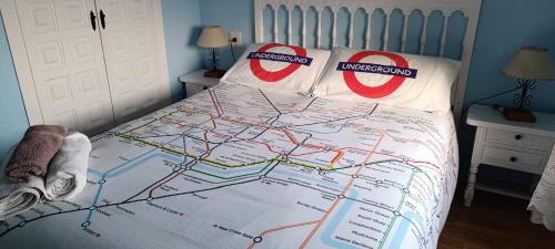 a bed with a map on it with colgate pillows at Villas Moraig in Benitachell