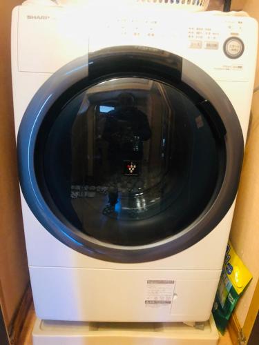 a washing machine is sitting on a shelf at Nara House R2 in Kawagoe