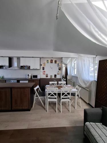 a dining room and kitchen with a table and chairs at Apartment 15 in Borovets