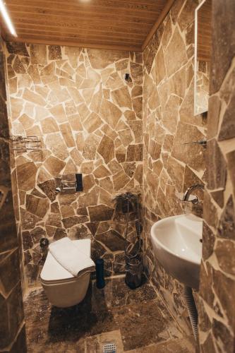 a bathroom with a toilet and a sink at Turan Cappadocia Cave in Goreme