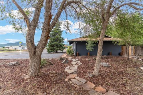 a building with trees in front of a street at Walk to GC Train Depot and Route 66, king beds, game room, BBQ, firepit in Williams