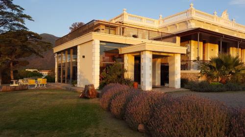 a large house with a garden in front of it at Montecassino in Capilla del Monte