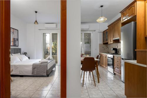 a kitchen and a bedroom with a bed and a table at Ionian Nest in Argostoli
