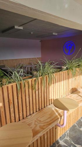 a restaurant with a table and potted plants at The Little Island Boutique Motel in Clonakilty