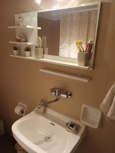 a bathroom with a sink and a mirror at Floor in Alexandroupoli