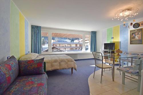 una sala de estar con un sofá y una mesa en RAINALTER Studio 14A Centrale, en Madonna di Campiglio