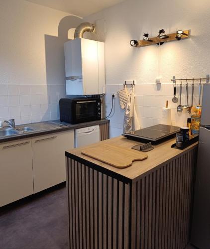 a kitchen with a counter with a laptop on it at Bel appartement hyper centre in Dax