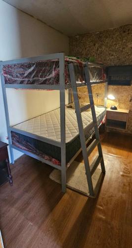 a bunk bed in a room with a wooden floor at Casa Cipres in Laredo Hacienda