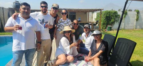 a group of people posing for a picture by a pool at Casa Cipres in Laredo Hacienda