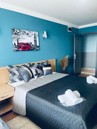 a bedroom with a large bed with a blue wall at Grand Alisa Hotel (Ex. Royalisa Hotel) in Alanya