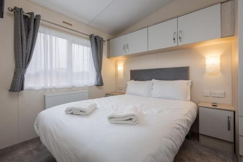Ένα ή περισσότερα κρεβάτια σε δωμάτιο στο Galtres Lodge close to Pickering