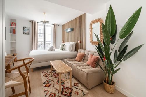 un salon avec un canapé et un lit dans l'établissement SERENERS - Charming Serviced Apartments - Saint Germain, à Paris