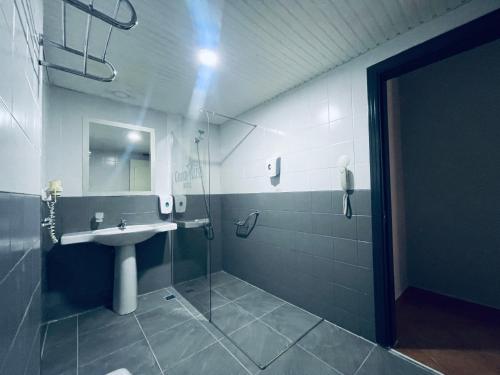 a bathroom with a sink and a shower with a mirror at Grand Alisa Hotel (Ex. Royalisa Hotel) in Alanya