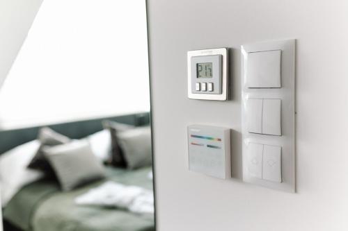 a living room with a couch and a light switch at GOLDEN HAUS Opole - SkyLOFT & MiniLOFT in Opole