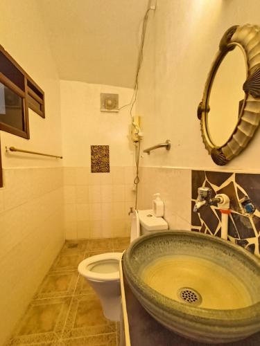 a bathroom with a sink and a toilet at Casa de Arte in Boracay