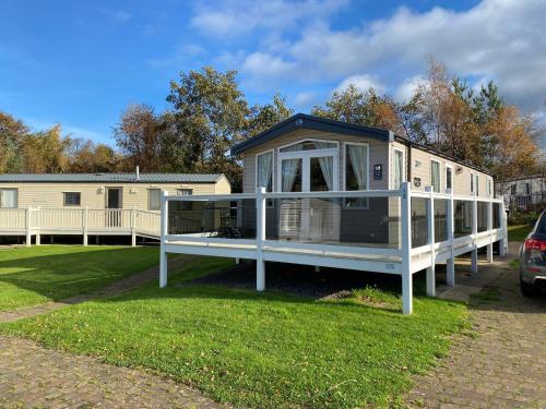 a tiny house is parked in a yard at Luxury Caravan Escape by the Seaside Port Seton in Prestonpans