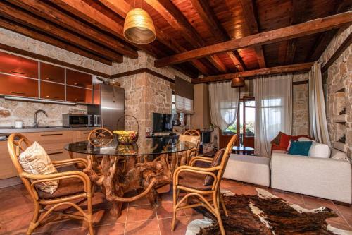 a kitchen and living room with a table and chairs at Michaela in Kassandria