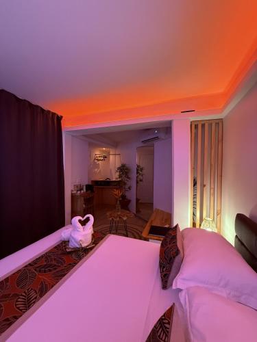 a bedroom with a large bed and a living room at Ononui Airport Studio in Faaa