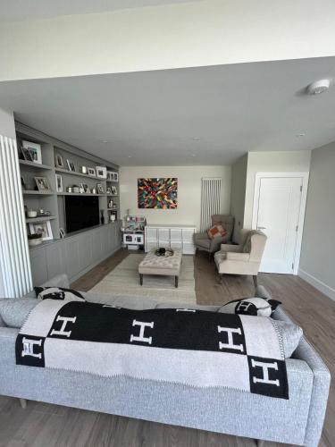 a bedroom with a bed and a living room at Luxury 4 Bedroom Home, South Dublin in Blackrock