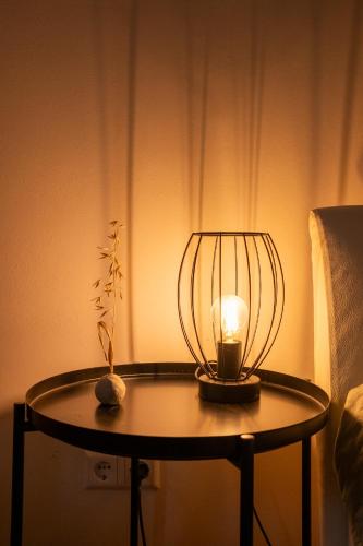 a lamp on a table next to a bed at Savoy in Althofen