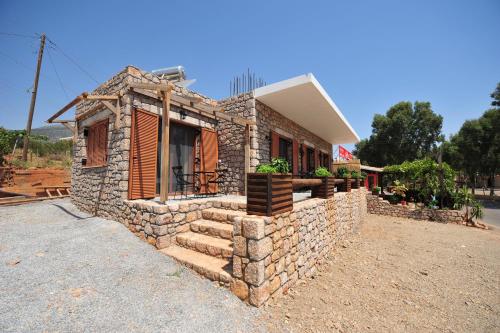 a small stone house with a stone wall at Casa Gustosa Μονεμβασιά in Monemvasia