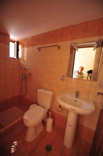 a bathroom with a toilet and a sink at Casa Gustosa Μονεμβασιά in Monemvasia