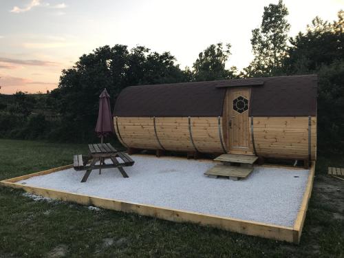a play house with a bench and an umbrella at Le Tonneau Bourguignon in Saint-Léger-sur-Dheune