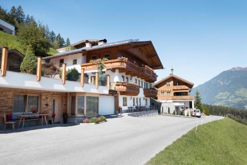 a house in the mountains with a driveway at Landhaus Rieder im Zillertal in Aschau