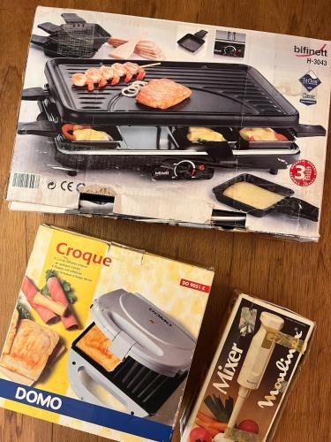 a model of a grill and a magazine on a table at Charmant vakantiehuis aan de Ourthe in Maboge La Roche en Ardenne in La Roche-en-Ardenne