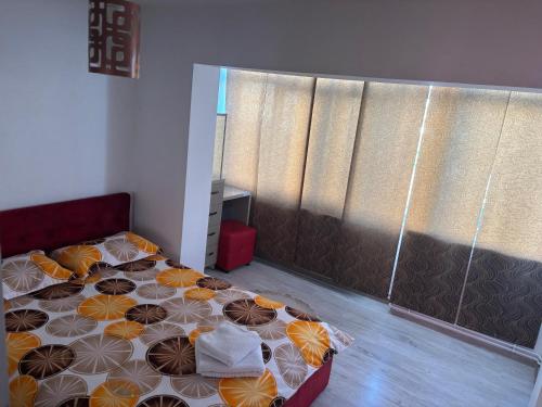 a bedroom with a bed with umbrellas on it at Apartament SUN Drăgășani in Drăgăşani