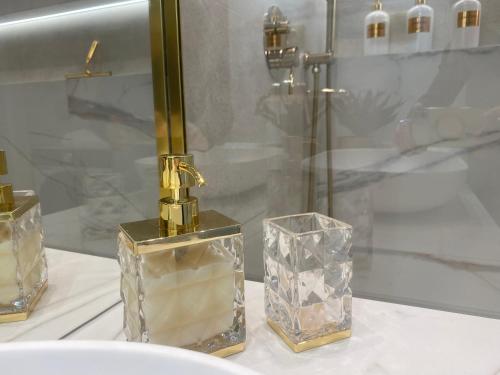 a group of perfume bottles sitting on a table at Apartament DeLuxe Zamość Prywatny parking podziemny in Zamość