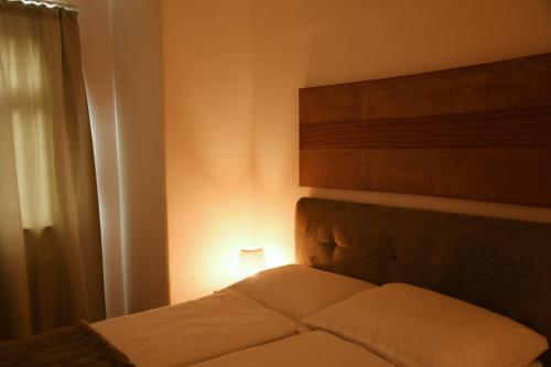 a bedroom with a bed with a light on it at Engel Apartments in Hard