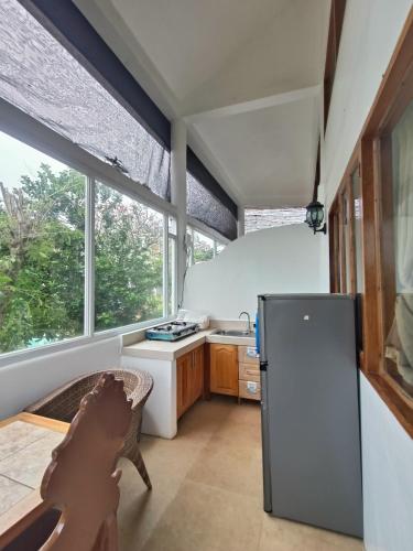 a kitchen with a refrigerator and a sink at Casa de Arte in Boracay