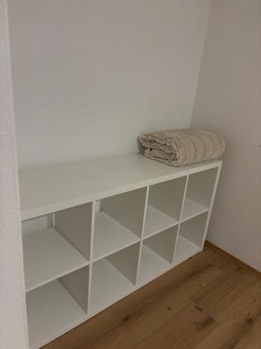a white shelf in the corner of a room at Moderne Wohnung in Linz