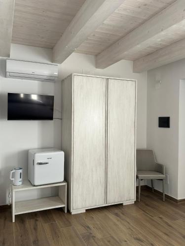 a living room with a cabinet and a chair at La Casetta della Nonna in Belmonte Calabro