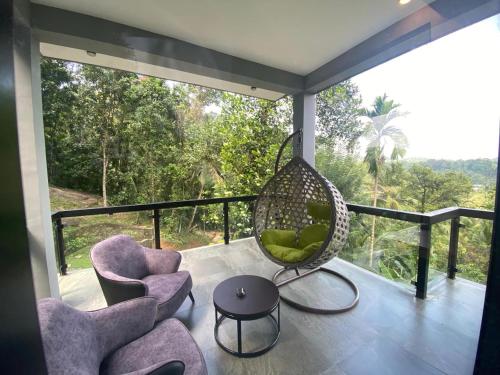 a room with two chairs and a swing on a balcony at The Cube in Kegalle