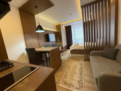 a living room with a couch and a table at Fashion Residence Hill in Kopaonik