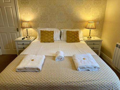 a bedroom with a bed with towels on it at The Crescent York in York