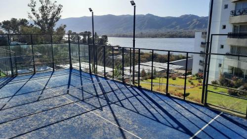 a balcony of a building with a view of the water at Veneto Village Resort & Spa in Villa Carlos Paz