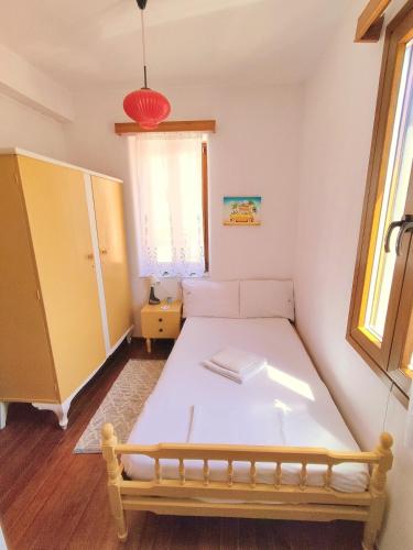 a small room with a bed and a window at Lovely 2-bedroom with panoramic view in Skopelos Town