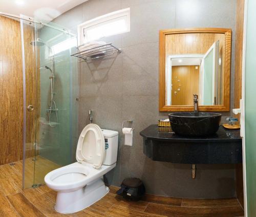 a bathroom with a toilet and a sink at Nguyên Thái in Ho Chi Minh City
