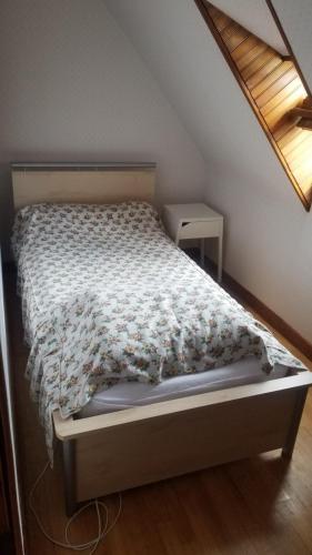 - une chambre avec un lit et une couette en fleurs dans l'établissement Maison récente type traditionnelle 9 couchages, à Trizac