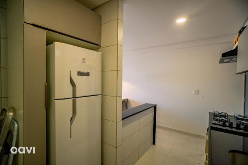 a kitchen with a white refrigerator and a counter at Flats Confortáveis em Manaíra Mindset - Qavi in Tambaú