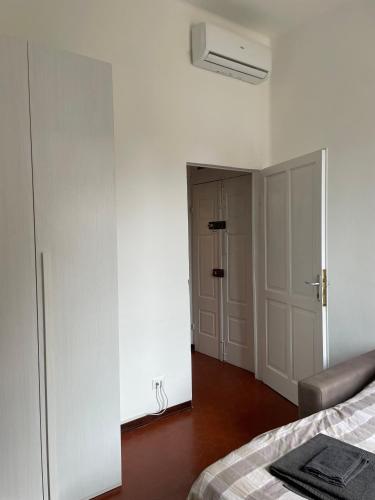 a white bedroom with a bed and a closet at Casa Mantovana in Mantova