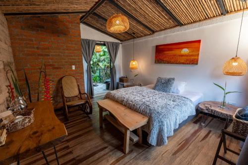 a bedroom with a bed and a table at La Herradura lodge in Santa Rosa de Cabal